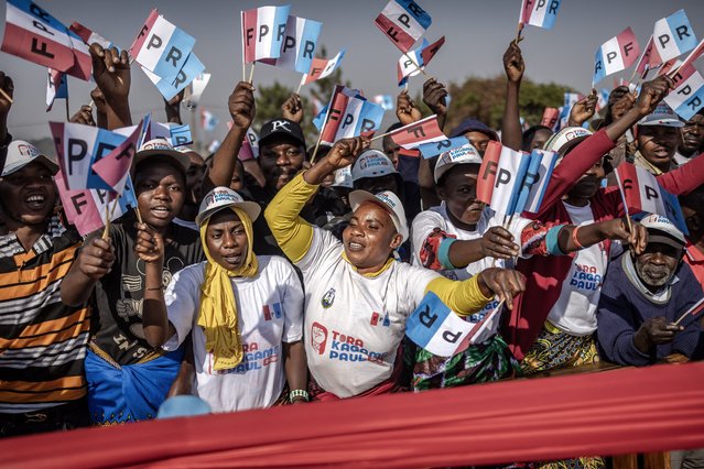 Rwandan Patriotic Front (RPF) supporters wave party flags and chant slogans in support of the Incumbent President of Rwanda and presidential candidate Paul Kagame during a campaign rally in Kigali, on July 12, 2024 ahead of the 2024 Rwandan general election. A country of 26,000 km2 which plays in the big leagues: with military force, image work and influence, Paul Kagame has made Rwanda a major strategic player, skillfully playing this role to develop the country and establish his power. Paul Kagame, who is seeking a fourth presidential term on Monday, has effectively led this landlocked country in Great Lakes Africa since the end of the Tutsi genocide in 1994, and as president since 2000. (Photo by Luis Tato/AFP Photo)