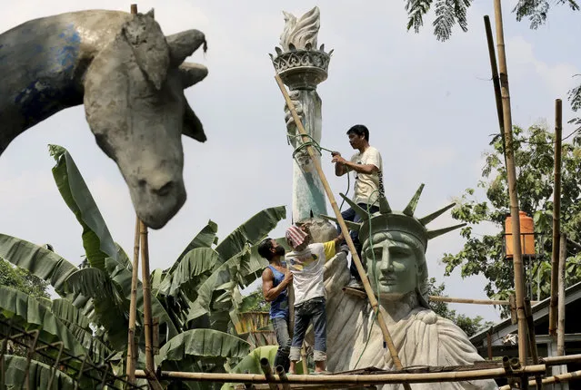 Workers build a large replica of the Statue of Liberty at a workshop in Jakarta, Indonesia, Thursday, May 4, 2017. The sculpture which costs 170 million Rupiah (U.S $ 17,000) to make will be installed at a public park to attract visitors. (Photo by Tatan Syuflana/AP Photo)