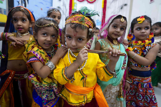 Indian school children, dressed as Hindu god Krishna and his consort Radha, participate in celebrations ahead of Janmashtami, the festival that marks the birth of Krishna, at a school in Ahmedabad, India, Friday, August 23, 2024. (Photo by Ajit Solanki/AP Photo)