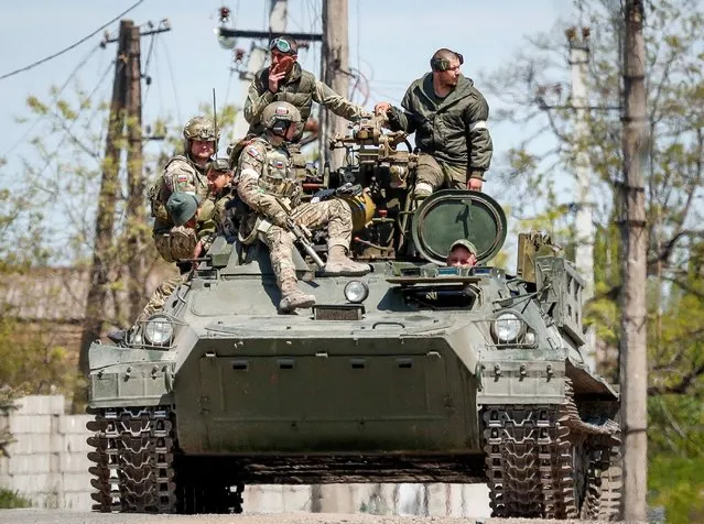 Russian service members are seen atop of an armoured vehicle during Ukraine-Russia conflict in the southern port city of Mariupol, Ukraine on May 11, 2022. (Photo by Alexander Ermochenko/Reuters)