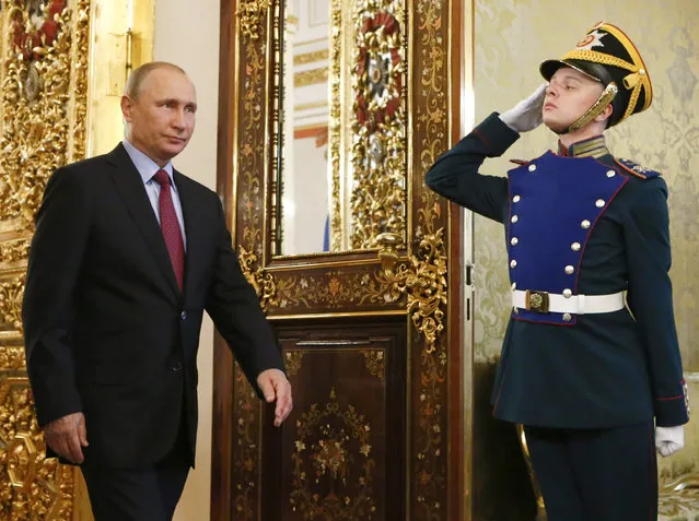 Russian President Vladimir Putin, left, walks past an honour guard before a meeting with his Brazilian counterpart Michel Temer at the Kremlin, in Moscow, Russia, Wednesday, June 21, 2017. (Photo by Sergei Karpukhin/Pool Photo via AP Photo)