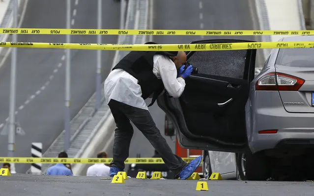 A police investigator takes pictures of a vehicle after an attack on a police station in Istanbul, Turkey, August 10, 2015. (Photo by Huseyin Aldemir/Reuters)