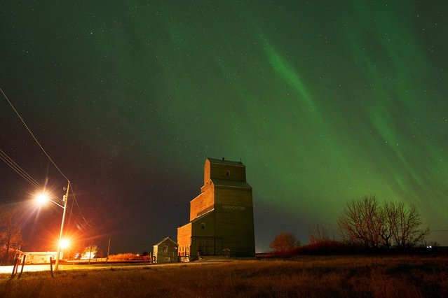 The aurora borealis, also known as the northern lights, light up the sky over an old grain elevator in Brant, Alberta, Canada on October 7, 2024. (Photo by Todd Korol/Reuters)