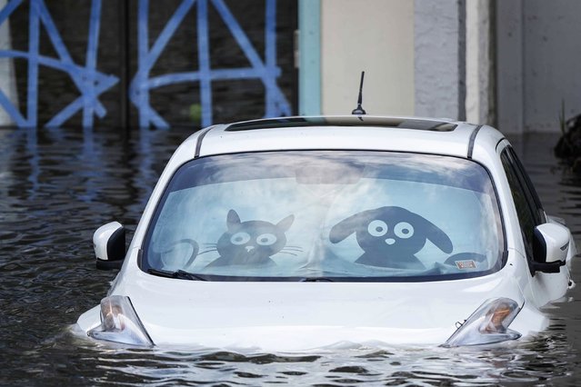 A car is submerged in flood water at an apartment complex in the aftermath of Hurricane Milton, Thursday, October 10, 2024, in Clearwater, Fla. (Photo by Mike Stewart/AP Photo)