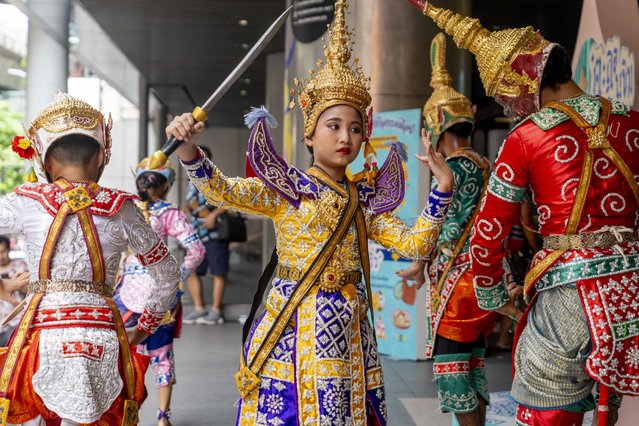 A troupe of adolescent traditional Thai Khon dancers perform in front of the Silom Complex mall in Bangkok, Thailand on September 6, 2024. Khon dancers perform in a martial combat-styled choreography, often holding replica weapons, with some performers wearing full face masks as well as ornate headdresses. The Ramakien, an adaptation of the Indian Hindu epic Ramayana, is the source of many of the stories reenacted in Khon performances. Khon dance has been performed in Thailand since the Ayutthaya period. (Photo by Adryel Talamantes/ZUMA Press Wire/Rex Features/Shutterstock)