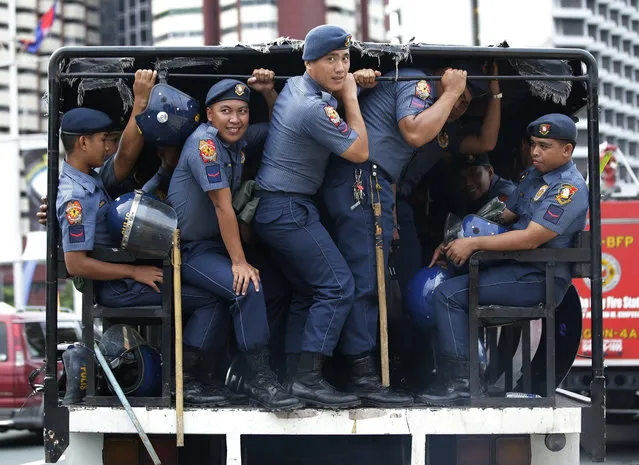 Police ride at the back of a truck near the venue of the 50th Association of Southeast Asian Nations Foreign Ministers' Meeting and its regional partners in Manila, Philippines on Thursday, August 3, 2017. Washington is seeking talks on how North Korea can be suspended from Asia's biggest security forum as part of a broader effort to isolate Pyongyang diplomatically and force it to end its missile tests and abandon its nuclear weapons program, U.S. and Philippine officials said. (Photo by Aaron Favila/AP Photo)