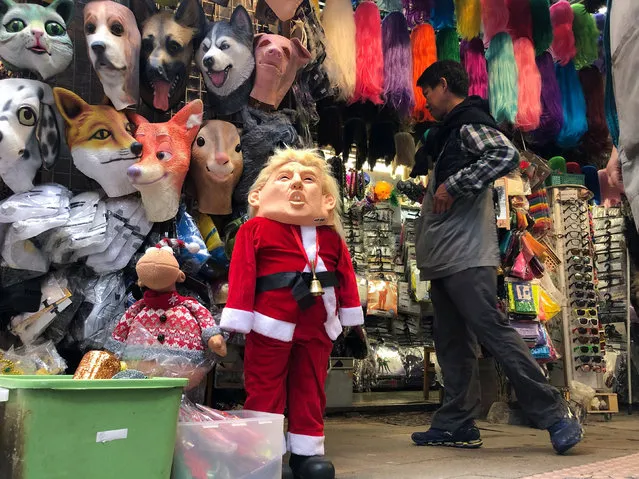 A U.S. President Donald Trump mask is seen for sale in a market in Hong Kong, China, December 23, 2019. (Photo by Lucy Nicholson/Reuters)