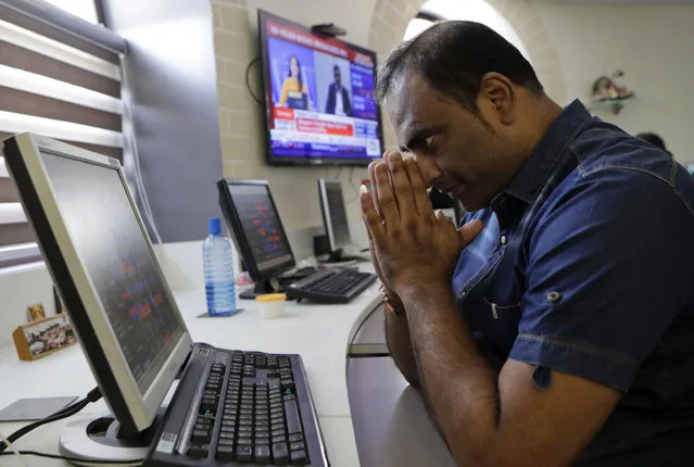 An Indian stockbroker gestures as he watches the Bombay Stock Exchange (BSE) index on a trading terminal in Mumbai, India, Monday, March 9, 2020. Global stock markets and oil prices plunged Monday after a squabble among crude producers jolted investors who already were on edge about the surging costs of a virus outbreak. India's Sensex retreated 6.2% to 35,255.73. (Photo by Rajanish Kakade/AP Photo)