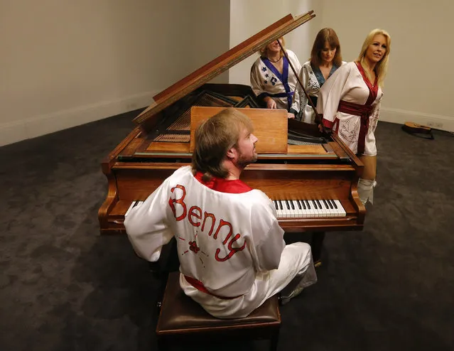 Actors of the ABBA show “Bjoern Again” perform on a piano at Sotheby's auction house in London, Thursday, August 27, 2015. (Photo by Frank Augstein/AP Photo)
