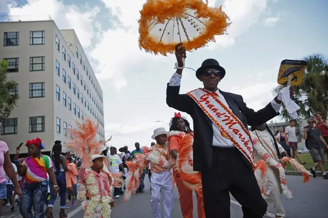 The Original Big 7 Junior Steppers parade through the Central Business District in a second line parade to mark the tenth anniversary of Hurricane Katrina in New Orleans, Louisiana August 29, 2015. (Photo by Edmund D. Fountain/Reuters)