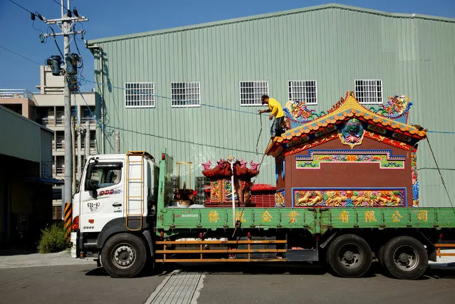 A ready-made Chinese traditional temple is seen on a lorry during delivery to a customer in Taichung, Taiwan July 6, 2016. (Photo by Tyrone Siu/Reuters)