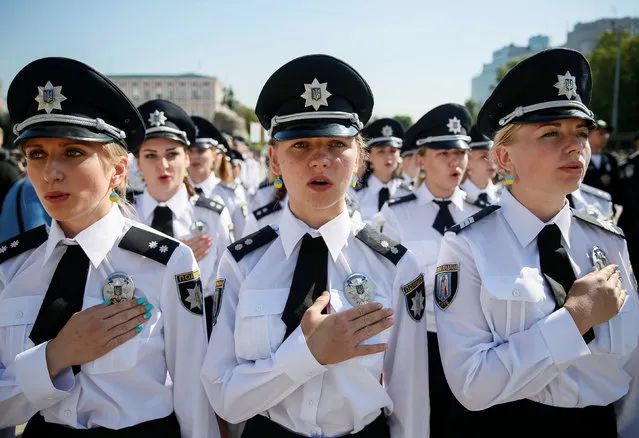 Police officers sing the national anthem during a ceremony to mark the 1st anniversary of a reformed police service, part of Interior Ministry reforms which introduced road, metro and foot police patrols, in Kiev, Ukraine August 4, 2016. (Photo by Gleb Garanich/Reuters)