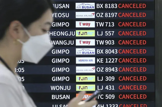 An electronic signboard shows canceled flights as Typhoon Hinnamnor travels toward the Korean Peninsula at Jeju International Airport on Jeju Island, South Korea, Monday, September 5, 2022. (Photo by Byun Ji-chul/Yonhap via AP Photo)