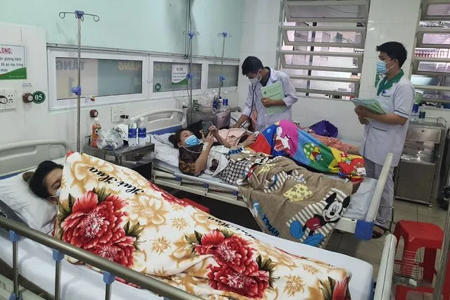 Victims of karaoke parlor fire are treated in a hospital Wednesday, September 7, 2022, in Thuan An city, southern Vietnam. Over a dozen people died in the fire local media reported. (Photo by Duong Trei Tuong/VNA via AP Photo)