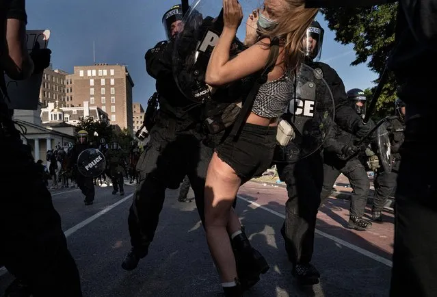 Riot police rush demonstrators as they clear Lafayette Park and the area around it across from the White House for President Donald Trump to be able to walk through for a photo opportunity in front of St. John's Episcopal Church near the White House, in Washington, June 1, 2020. (Photo by Ken Cedeno/Reuters)