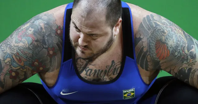 Fernando Saraiva Reis, of Brazil, prepares to attempt a lift in the men's +105 kg weightlifting event at the 2016 Summer Olympics in Rio de Janeiro, Brazil, Tuesday, August 16, 2016. (Photo by Mike Groll/AP Photo)