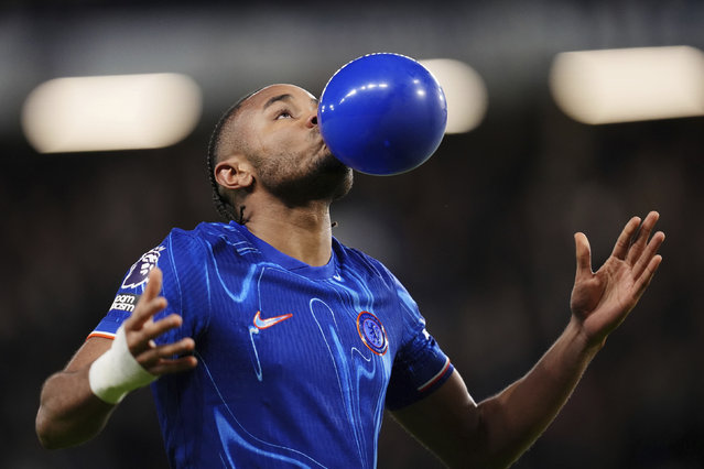 Chelsea's Christopher Nkunku celebrates scoring their side's first goal of the game during the English Premier League soccer match between Chelsea and Southampton at Stamford Bridge, London, Tuesday, February 25, 2025. (Photo by John Walton/PA Wire via AP Photo)