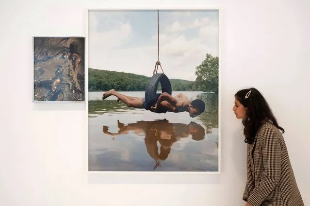 Chrysalis is an exhibition of new photographs by Tyler Mitchell exploring themes of Black history and Southern identity in “Chrysalis”, his first solo exhibition at Gagosian, London on October 6, 2022. Image: A Glint of Possibility represents a figure on a tire swing suspended above the surface of a lake, frozen in perfect equilibrium. (Photo by Malcolm Park/Alamy Live News)