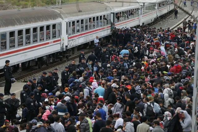Migrants wait to board a train at the station in Tovarnik, Croatia, September 20, 2015. (Photo by Antonio Bronic/Reuters)
