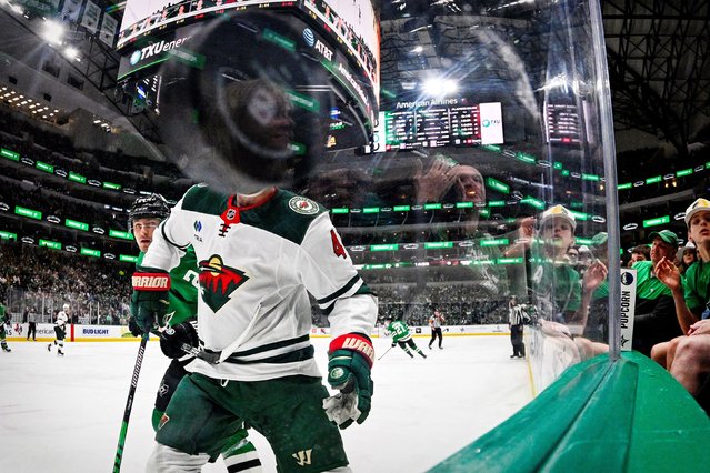 The puck flies in front the glass at American Airlines Center during an NHL game in Dallas on Monday, March 24, 2025. (Photo by Jerome Miron/Imagn Images/Reuters)