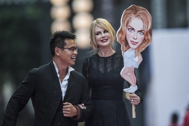 Mission Hills Group Chairman Ken Chu and Australian actress Nicole Kidman on the red carpet during the Opening Ceremony in Haikou ahead of the Mission Hills Celebrity Pro-Am, on the southern Chinese island of Hainan, on October 23, 2014. (Photo by Xaume Olleros/AFP Photo)