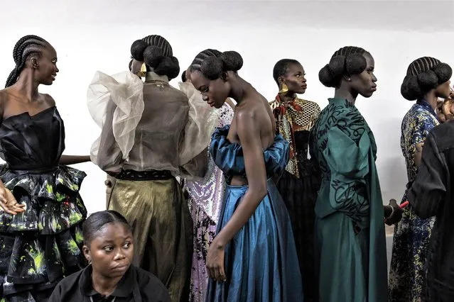 Models wait to get their make-up finished during Dakar fashion week on Goree Island in Dakar, Senegal, on December 03, 2022. The 20th anniversary of Dakar fashion week is held in a preserved colonial era fort on Goree island, which was one of Africa’s biggest slave trading centres during the 15th and 16th century. (Photo by John Wessels/AFP Photo)