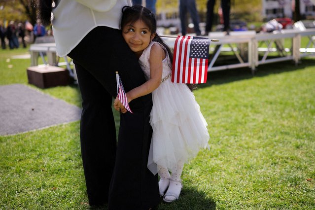 Sherlyn, 4, hugs her mother, Maria Pomaquiza, at a naturalization ceremony in Lexington, Massachusetts, on Tuesday, April 22, 2025. Pomaquiza, who is originally from Ecuador, was sworn in as a US citizen. (Photo by Brian Snyder/Reuters)
