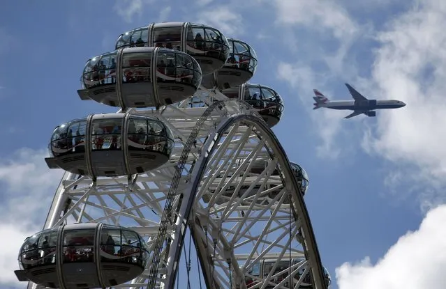 A Heathrow bound airliner flies above the London Eye ferris wheel in London, Britain July 31, 2016. (Photo by Peter Nicholls/Reuters)