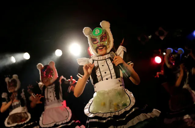 Members of Japan's idol group “Virtual Currency Girls” wearing cryptocurrency-themed masks perform in their debut stage event in Tokyo, Japan, January 12, 2018. Then they launched into “The Moon, Cryptocurrencies and Me”, a stirring anthem incorporating lines such as “Be careful about your password! Don't use the same one!” to warn against the dangers of trading cryptocurrency. (Photo by Kim Kyung-Hoon/Reuters)