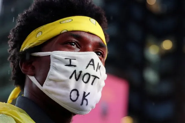 A demonstrator wearing a face mask takes part in a protest following the death of the Black man Daniel Prude, after police put a spit hood over his head during an arrest in Rochester on March 23, at Times Square in New York, U.S. September 3, 2020. (Photo by Shannon Stapleton/Reuters)