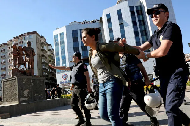 Riot policemen detain a demonstrator during a protest against the suspension of teachers from classrooms over purported links with Kurdish militants, in Diyarbakir, Turkey, September 19, 2016. (Photo by Sertac Kayar/Reuters)