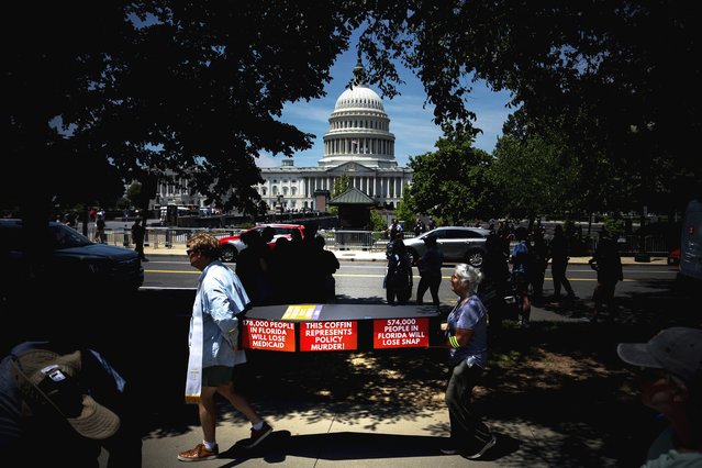 Demonstrators carry cardboard caskets in front of the U.S. Capitol in protest of President Donald Trump's tax breaks and spending cuts package, Monday, June 30, 2025, in Washington. (Photo by Julia Demaree Nikhinson/AP Photo)
