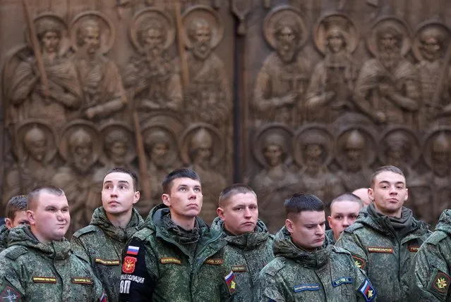 Russian service personnel attend a service led for believers, including multi-child families, Russia's soldiers involved in a military campaign in Ukraine and their relatives, at the Main Cathedral of the Russian Armed Forces near Moscow, Russia on January 15, 2023. (Photo by Yulia Morozova/Reuters)