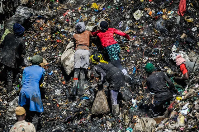 People collect items that are still intact to sell among waste material at Dandora, Nairobiâs main dump site, in Kenya on January 14, 2023. Covering an area of ââ30 acres, the Dandora is the livelihood of many Kenyans from Korogocho, Baba Ndogo and Dandora regions, although it poses serious health threats. (Photo by Gerald Anderson/Anadolu Agency via Getty Images)
