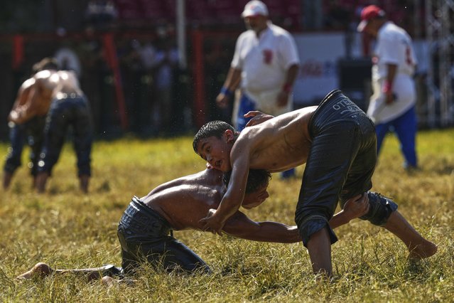Young wrestlers compete during the 664th annual Historic Kirkpinar Oil Wrestling championship, in Edirne, northwestern Turkey, Sunday, July 6, 2025. (Photo by Khalil Hamra/AP Photo)