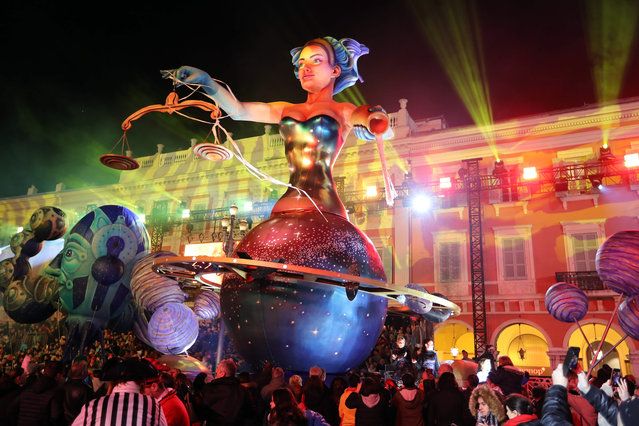 People look at the float of the Nice Carnival Queen as it parades in the streets of Nice for the 134 rd edition of the Nice Carnival in Nice, southeastern France on February 20, 2018. The 134 th carnival runs from February 17 until March 3, 2018, and celebrates this year the “King of Space”. (Photo by Valéry Hache/AFP Photo)