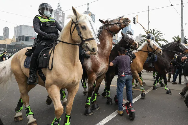 Police on horses setup a blockade on Princes Bridge to stop protesters in Melbourne during anti-lockdown rally on October 23, 2020. The protesters want the state government to remove regulations restricting the movement of citizens and the shutdown of businesses as they attempt to quash a second wave of infections. (Photo by Sydney Low/ZUMA Wire/Rex Features/Shutterstock)