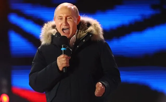 Russian President Vladimir Putin delivers a speech during a rally and concert marking the fourth anniversary of Russia's annexation of the Crimea region, at Manezhnaya Square in central Moscow, Russia on March 18, 2018. (Photo by David Mdzinarishvili/Reuters)