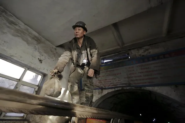 A miner comes out of a mine on a transmission band at a coal mine from the state-owned Longmay Group on the outskirts of Jixi, in Heilongjiang province, China, October 22, 2015. (Photo by Jason Lee/Reuters)