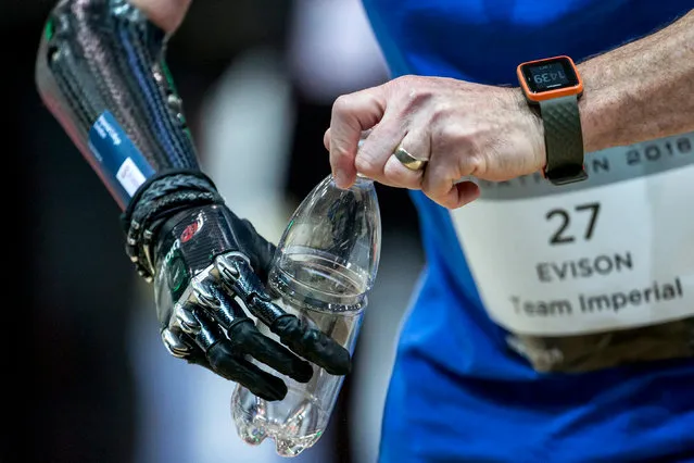 The hands of British Kevin Andrew Evison of Team Imperial open a bottle as he competes at the Powered Arm Prosthesis Race, during the first Cybathlon in Zurich, Switzerland, 08 October 2016. The first Cybathlon, a platform for the development of novel assistive technologies that are useful for daily life, is organised by the ETH Zurich. Individuals with physical disabilities will compete side by side in six demanding disciplines, using the latest assistive technologies. (Photo by  Alexandra Wey/EPA)