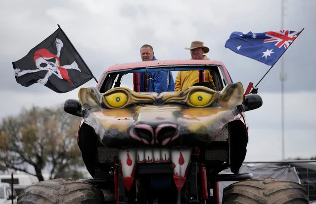 Operators of a monster truck bearing a skull and crossbones pirate flag alongside an Australian flag watch a national circle work championship of dirt driving at the Deni Ute Muster in Deniliquin, New South Wales, September 30, 2016. (Photo by Jason Reed/Reuters)