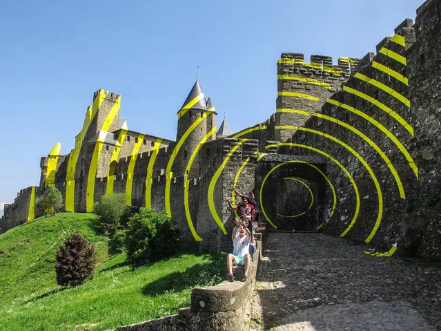 A view of the medieval castle of Carcassonne, southern France, 24 April 2018. Some walls of the castle are painted with yellow concentric circles created by Swiss artist Felice Varini, based in Paris, France, as celebrations of the 20th anniversary of inscription of Carcassonne as UNESCO World Heritage. The artwork will be removed in September 2018. (Photo by Armando Babani/EPA/EFE)