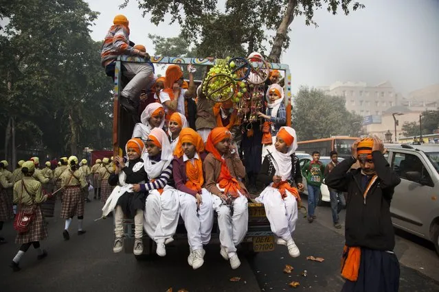 Indian Sikhs participate in a religious procession to mark the birth anniversary of Guru Gobind Singh, the tenth Sikh guru, in New Delhi, India, Sunday, December 28, 2014. (Photo by Tsering Topgyal/AP Photo)