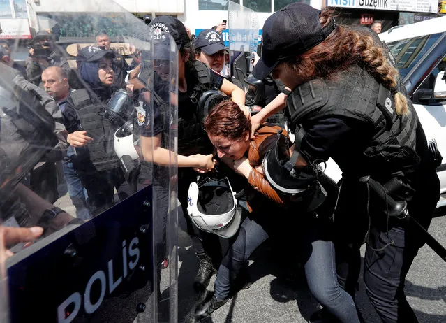 Turkish riot police scuffle with a group of protesters as they attempted to defy a ban and march on Taksim Square to celebrate May Day in Istanbul, Turkey May 1, 2018. (Photo by Murad Sezer/Reuters)
