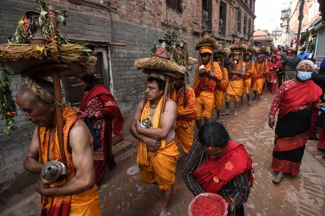 Hindu devotees participate in a religious procession during the month-long Madhav Narayan festival in Bhaktapur on the outskirts of Kathmandu on February 15, 2022. (Photo by Prakash Mathema/AFP Photo)