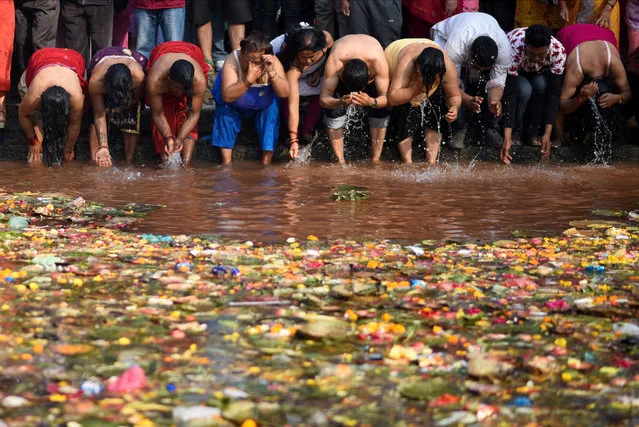 Devotees take a holy bath at Matathirtha to commemorate their departed mothers during Mother's Day in Kathmandu, Nepal on April 20, 2023. (Photo by Monika Malla/Reuters)