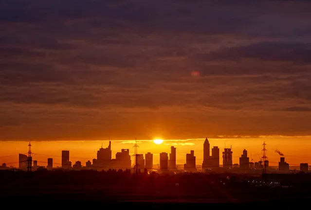 The sun rises over the buildings of the banking district in Frankfurt, Germany, Friday, November 20, 2020. (Photo by Michael Probst/AP Photo)