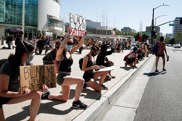 People get down on one knee during a demonstration over the police killing of George Floyd in downtown San Jose, Calif., on Wednesday, June 3, 2020. (Photo by Randy Vazquez/Bay Area News Group)