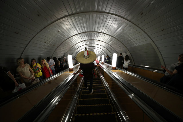 A Mexico's fan travels on the escalator at a metro station before the match between Germany and Mexico at the Luzhniki Stadium in Moscow, Russia on June 17, 2018. (Photo by Albert Gea/Reuters)