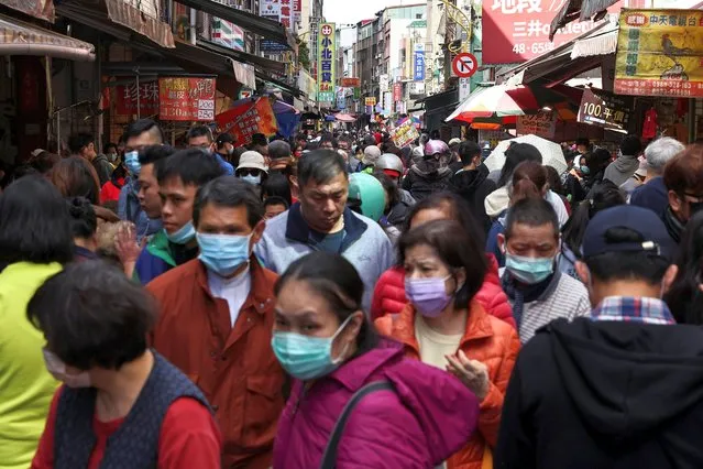 People shop while wearing a protective mask to prevent the spread of coronavirus disease (COVID-19) ahead of the Lunar New Year holiday in Taipei, Taiwan, February 10, 2021. (Photo by Ann Wang/Reuters)